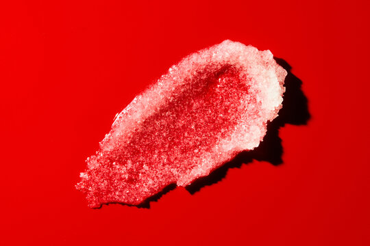 skincare product texture smeared over red surface