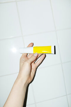 Hand holding mock up lotion tube with space for text or design 