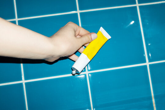 Hand holding mock up lotion tube with space for text or design 