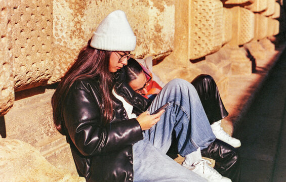 Analog portrait of two women resting during city walk