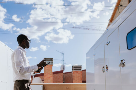Engineer inspecting industrial HVAC  equipment outdoors