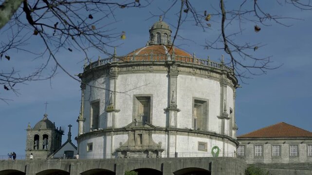 View of the monastery's stone facade under a clear blue sky.