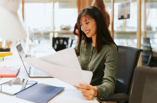 Professional woman working at a modern office desk