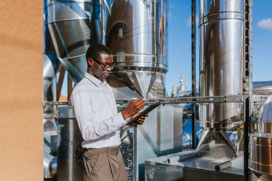 Industrial engineer using tablet at modern HVAC facility