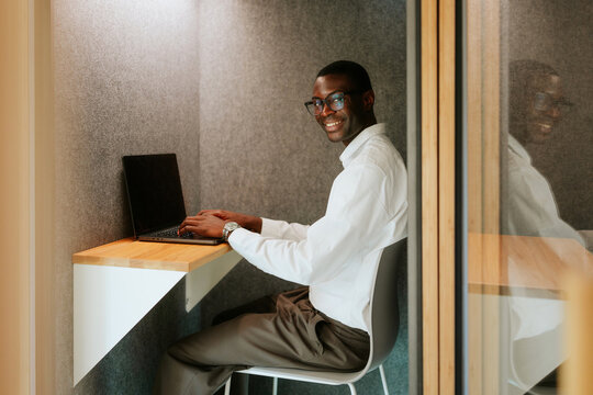 Professional working in modern office phone booth