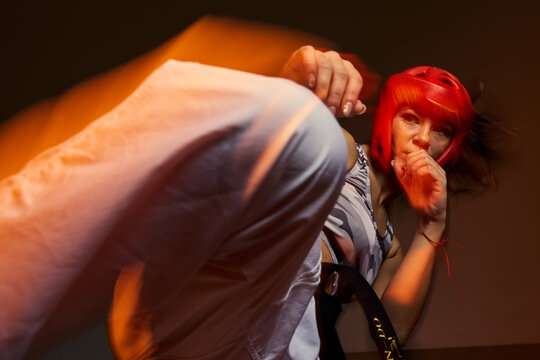 Fighter trains hard in a studio with motion and focus