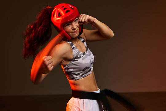 Female fighter practices punches in training session at gym