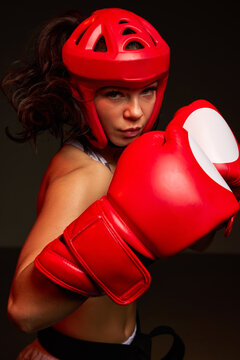 Female fighter prepares for a match in red gear