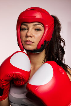 Boxer prepares for training with red gloves in gym setting