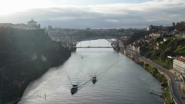 Perspective shot of the river banks and moving boats from above.