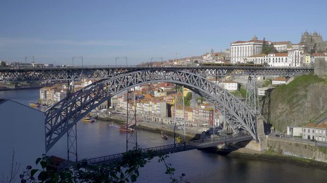 View of the iron bridge structure with the city of Porto in the background.
