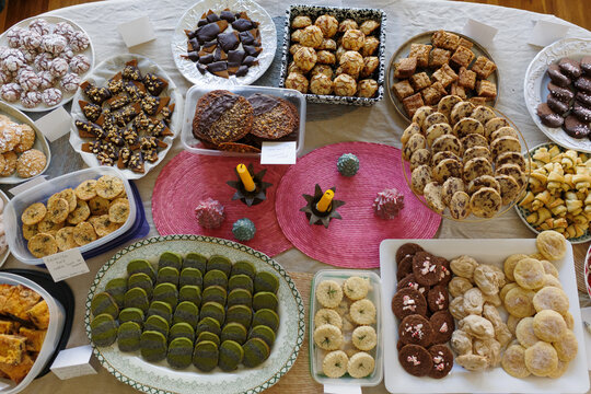 Elaborate spread of Christmas cookies on a large table for exchange