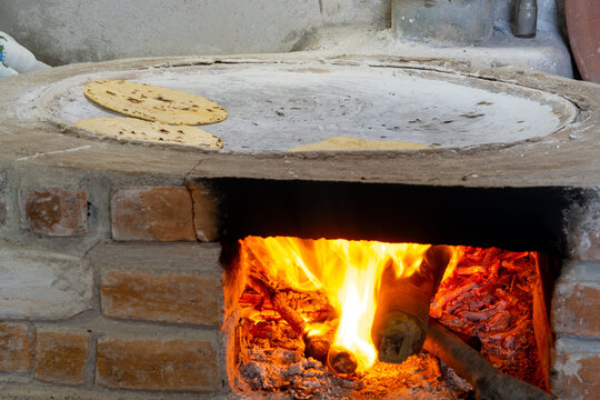 Traditional mexican tortillas cooking on wood fired comal