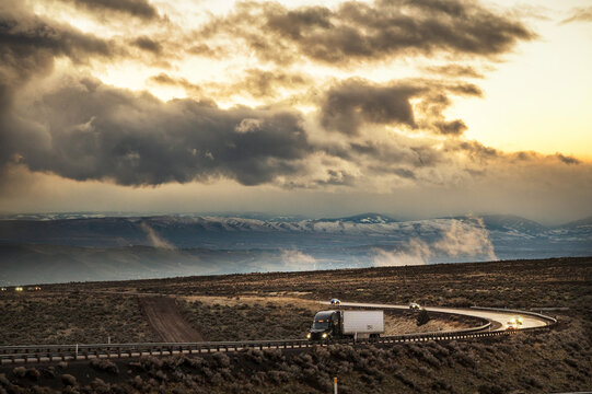 Cars and semi tractor transport trucks travel through  a severe storm along Interstate 84.  The high desert near Boise Idaho, USA.