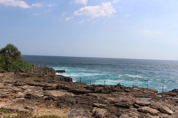 Dramatic rocky coastline and turquoise waves at Devil's Tears in Nusa Lembongan, Bali