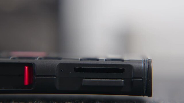 Extreme close-up of a hand inserting sd and microsd cards into a multi-format reader for data transfer and storage backup.