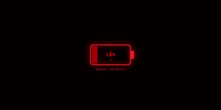 Low battery warning sign glowing red on a dark device screen