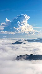 Dramatic cloud formation above a sea of low-lying fog and mountains