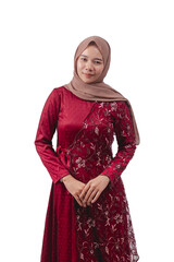 Smiling young woman in elegant red dress with hijab posing confidently