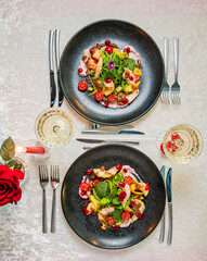Two elegant plates of gourmet salad with fresh ingredients for a romantic dining experience