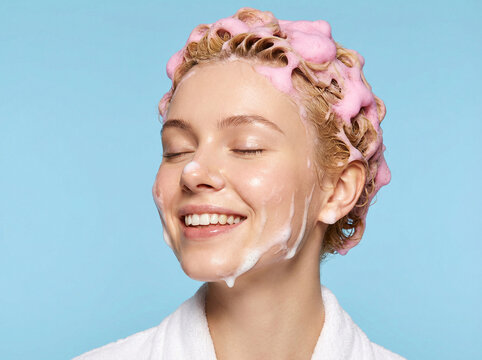 Beautiful Smiling Woman Washing Her Hair with Pink Shampoo Foam