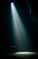Spotlight shining directly down onto an empty stage with a dark background, creating dramatic lighting and shadows