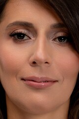 Elegant radiant beauty, Caucasian woman with shimmering eyelids and gentle expression, Poised female model showcases luminous skin and tasteful shimmer in studio setting