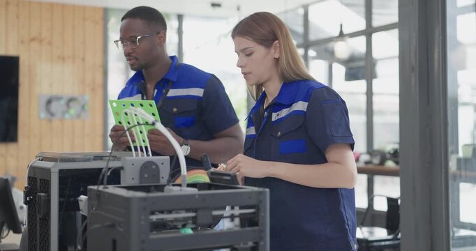 Engineers examine freshly printed 3D component in a workshop , showcasing advanced manufacturing and prototyping technology. Reflecting innovation, precision engineering, industrial design processes
