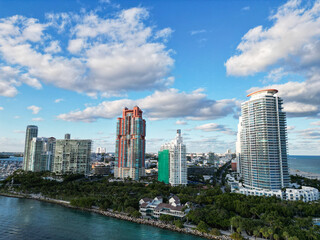 Obraz premium Aerial view of Miami Beach city by the coast. Miami Beach skyline. Scenic Miami Beach panorama famous coastline. Drone shot of Miami Beach above the shore.