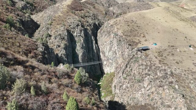 Chunkurchak, Kyrgyzstan December 16, 2025: Iconic Nebesnyy Most Sky Bridge suspended over stunning mountains, offering panoramic views, adventure, and breathtaking landscapes.