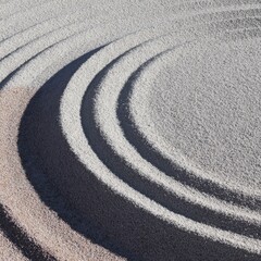 Naklejka premium Concentric sand circles in a zen garden for meditation and wellness. This minimal raked sand pattern with copy space is ideal for mindfulness and spa marketing backgrounds