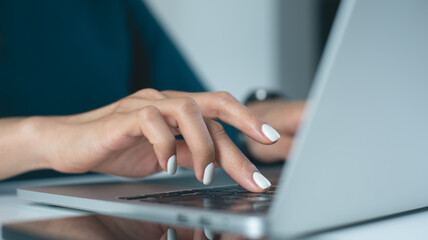 Woman hand typing on laptop computer keyboard, online working at home office, close up. online job....