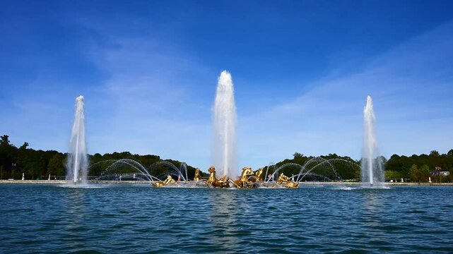 Apollo fountain in Versailles castle under a clear blue sky