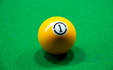 billiard balls number 1 on a green table
