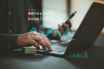 Person using laptop computer with digital stock market graphs and data analysis visualization