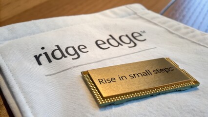 Modern Technology Chip on Fabric Background with Inspirational Message and Brand Name Highlighted in Soft Light