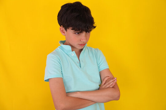 Angry preteen boy with arms crossed