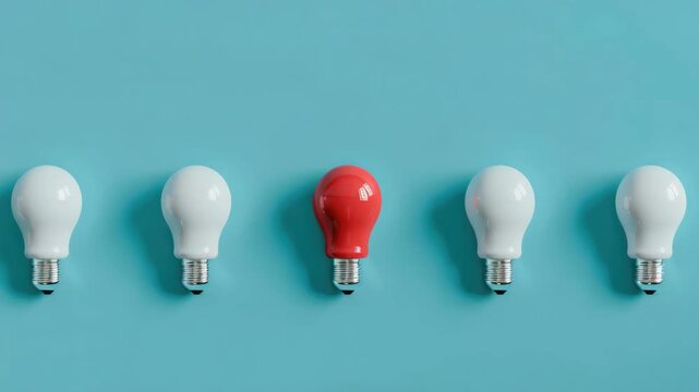 A row of light bulbs mounted on the wall with one red bulb in the middle.