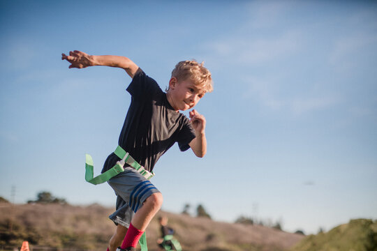 crossing fingers as boy runs