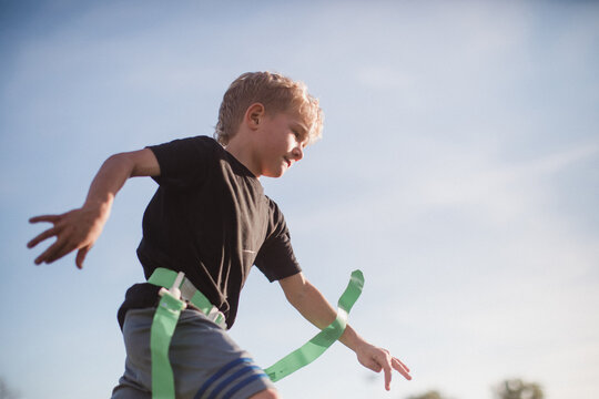 looking up at a boy running in flag football
