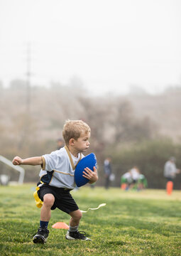 Boy playing flag football in fog