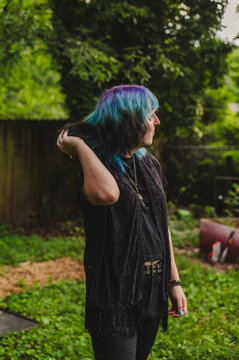 Blue Haired Person with a hand in their hair