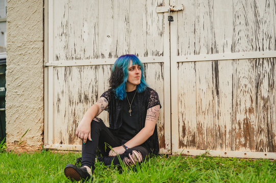 Queer Woman Leaning on a Wooden Door