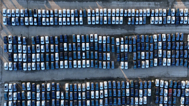 Huge lot full of brand new cars displaying mass storage