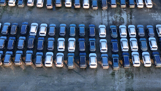 Aerial view of large parking lot filled with new car