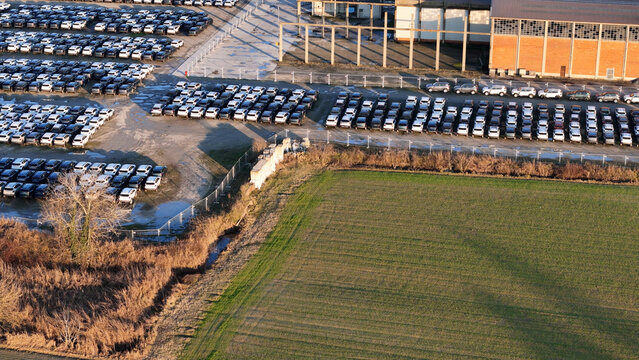 New cars, ready for transport, massive storage depot