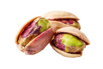 Close-up of three open nuts, revealing bright green and purple kernels