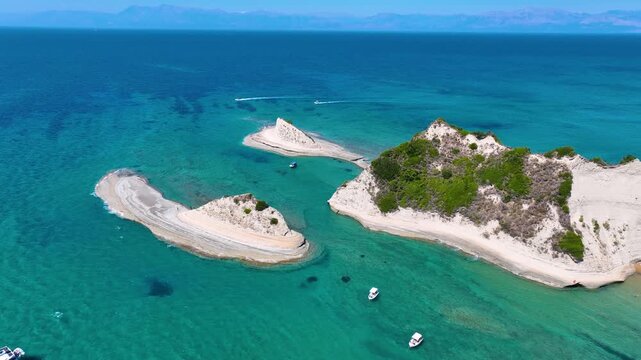 Stunning Aerial Drone Perspective of Cape Drastis Corfu Greece with Distinctive Limestone Formations and Catamarans Anchored in the Shallow Turquoise Waters
