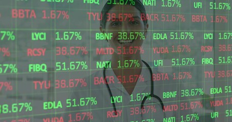 Standing doctor showing screen of green or red tickers in clinic, white coat, stethoscope, headband