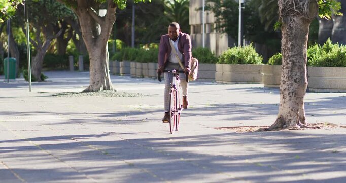 African american man riding on bike in the city